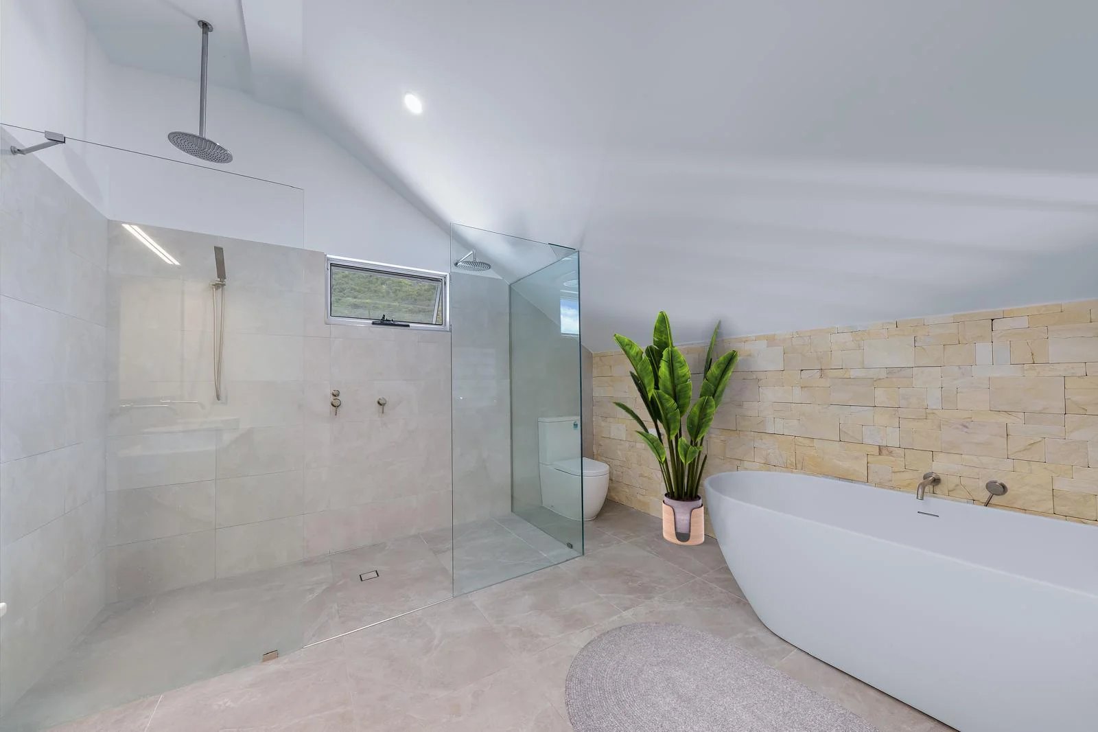 Private Hideaway Bay residence ensuite — walk-in shower, freestanding tub and stone feature wall